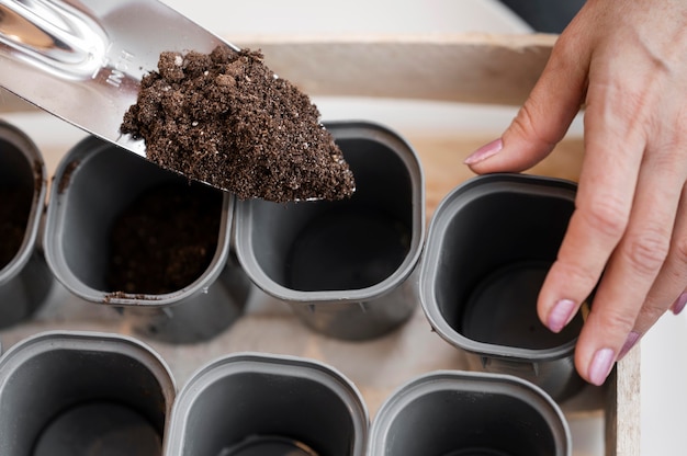 High angle of woman preparing soil for planting