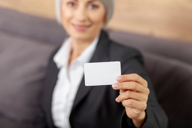 High angle woman presenting business card