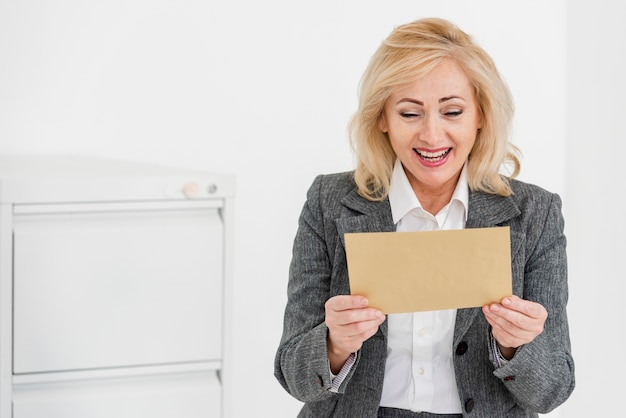 High angle woman reading envelope