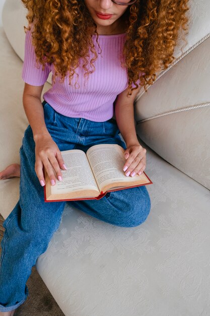 High angle woman reading at home