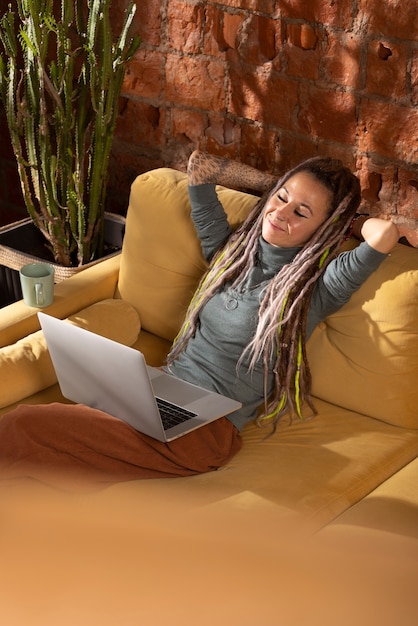 Free photo high angle woman reading on laptop