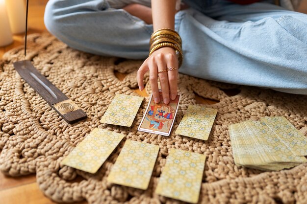 High angle woman reading tarot at home