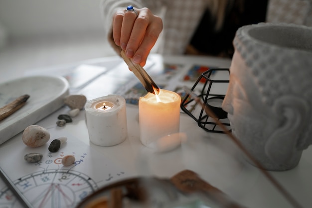 Free photo high angle woman reading tarot at home