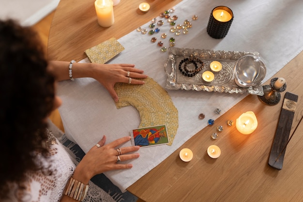 Free photo high angle woman reading tarot