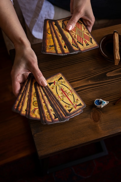 Free photo high angle woman reading tarot