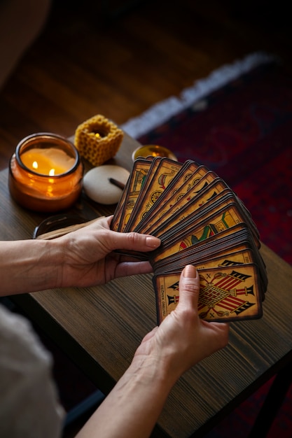 Free photo high angle woman reading tarot