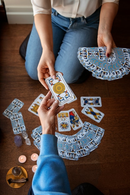 Free photo high angle woman reading tarot