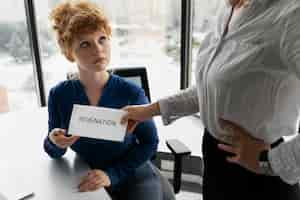 Free photo high angle woman receiving resignation note