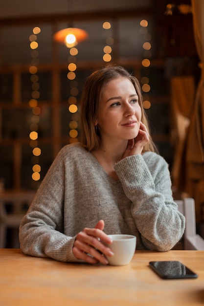 Free photo high angle woman at restaurant