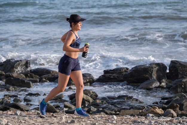 High angle woman running at seaside