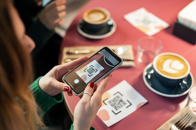 High angle woman scanning qr code