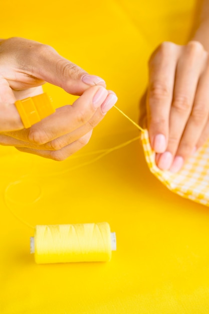 High angle of woman sewing fabric