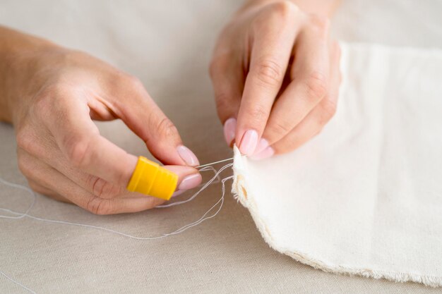 High angle of woman sewing fabric