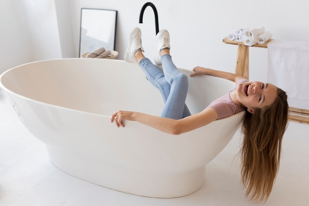 Free photo high angle woman staying in an empty bathtub