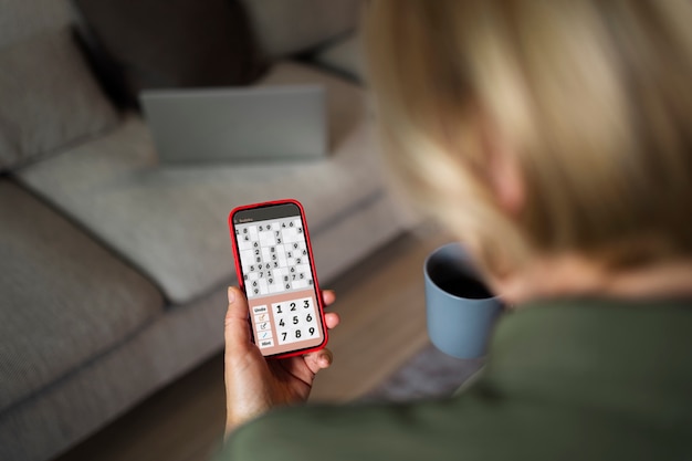 Free photo high angle woman taking a break with smartphone