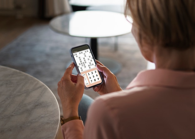 Free photo high angle woman taking a break with smartphone