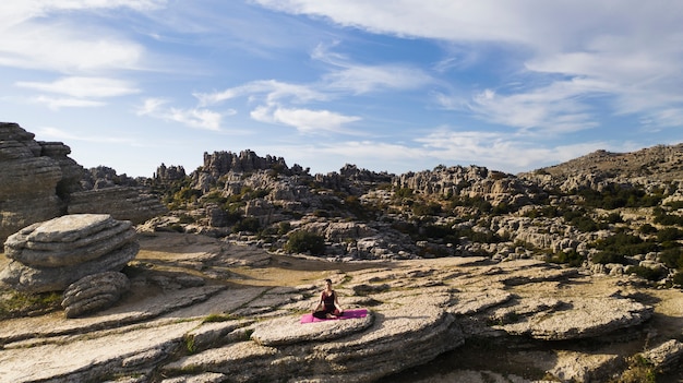 Free photo high angle woman on top of mountain practice