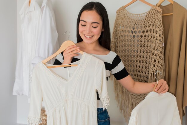 High angle woman trying on clothes