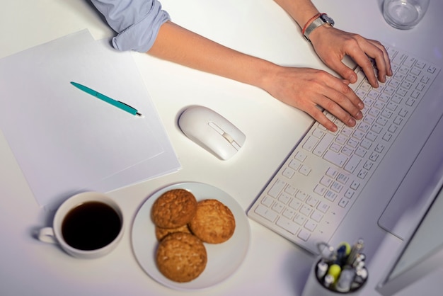 Free photo high angle woman typing on keyboard