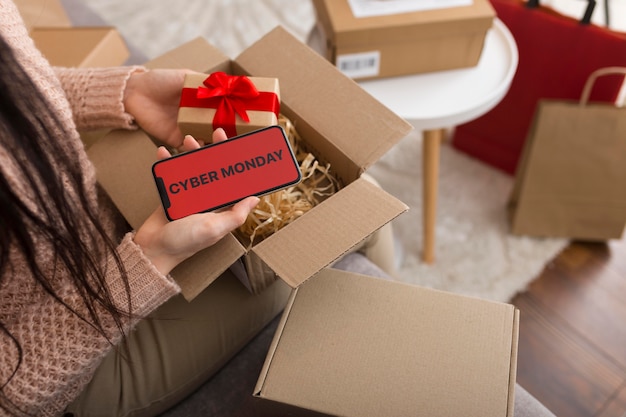 High angle woman unboxing a cyber monday package with copy space