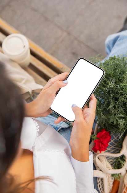 High angle of woman using her smartphone outdoors