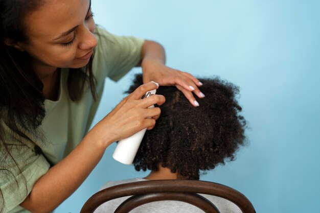 High angle woman using lices treatment