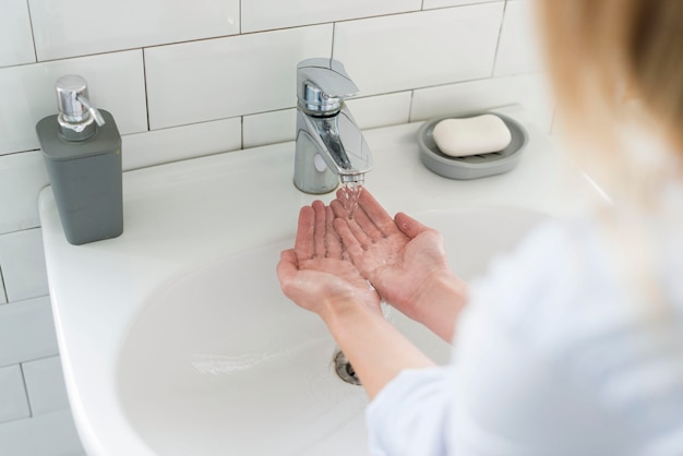 High angle of woman washing her hands