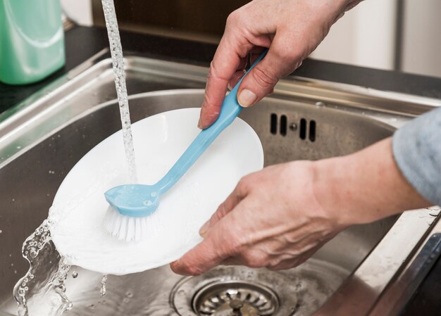 High angle of woman washing a plate