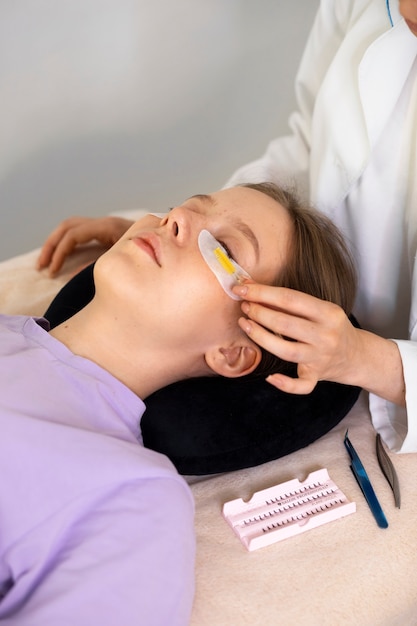 Free photo high angle woman wearing eye patches