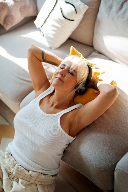 High angle woman wearing headphones
