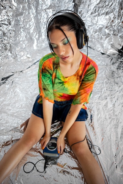 High angle woman wearing headphones