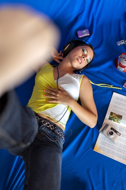 High angle woman with 2000s items