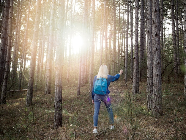 High angle woman with backpack in forest