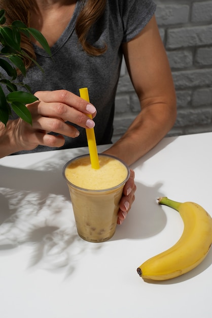 Free photo high angle woman with bubble tea