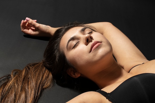 High angle woman with hydrated skin laying