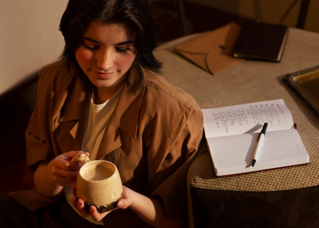 Free photo high angle woman with journal at home