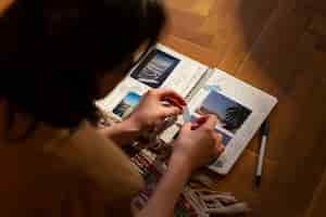 Free photo high angle woman with journal at home