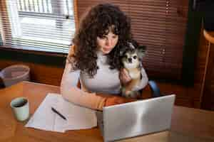 Free photo high angle woman with laptop at home