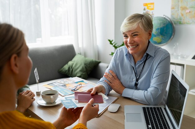 Free photo high angle woman working as a travel agent