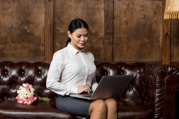 High angle woman working on laptop