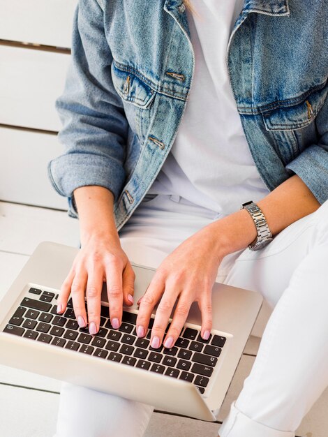 High angle of woman working on laptop