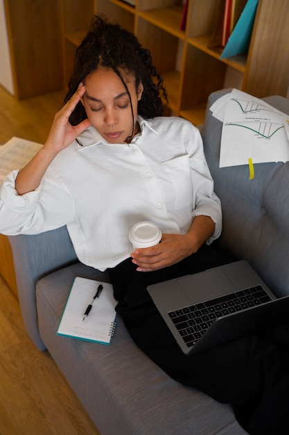 High angle woman working on laptop