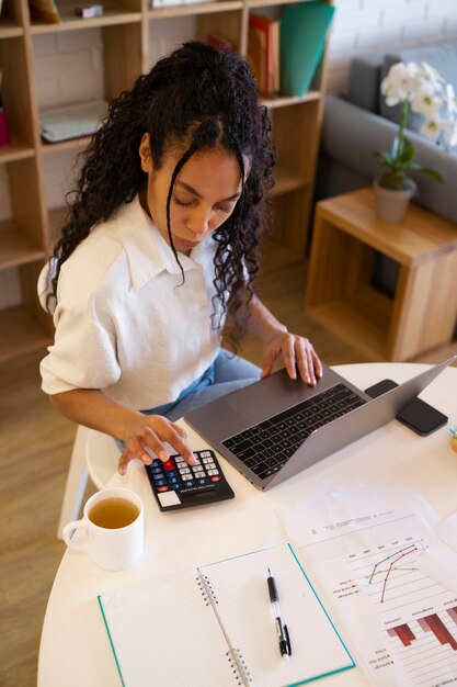 High angle woman working on laptop