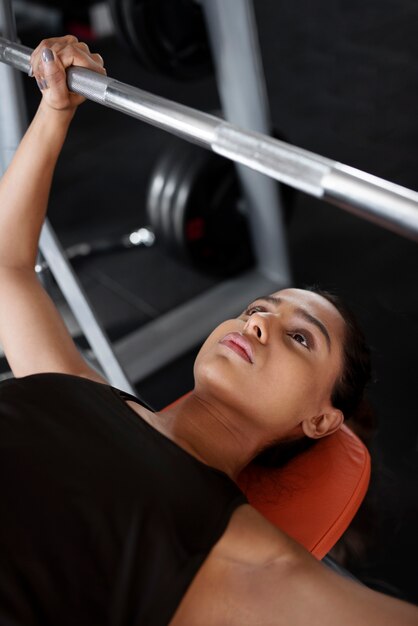 High angle woman working out with barbell