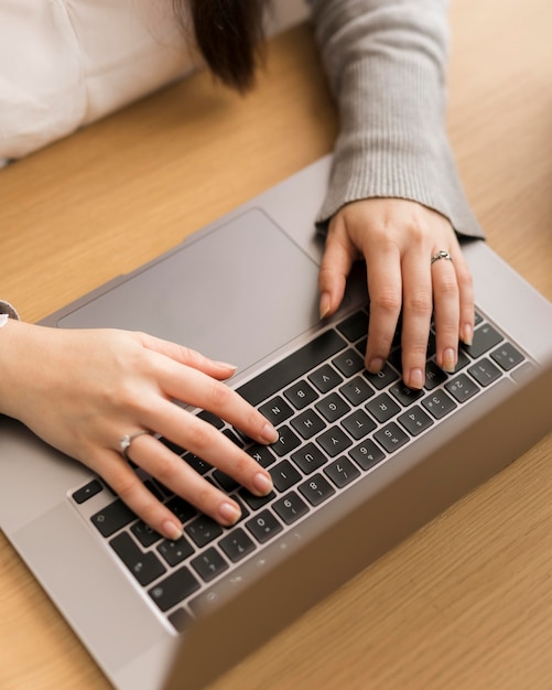 High angle woman wotking on laptop