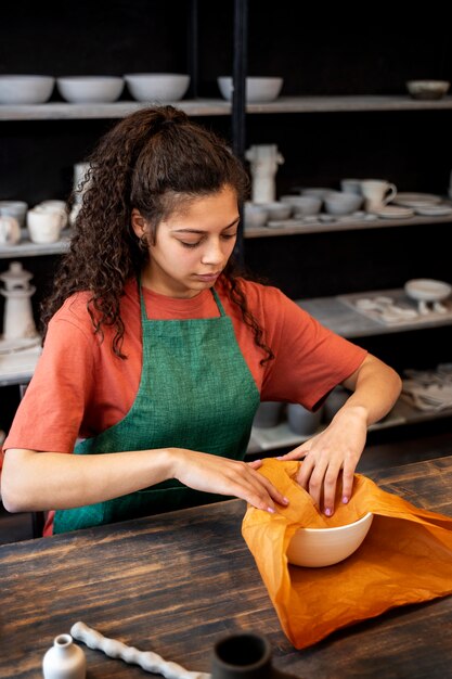 High angle woman wrapping bowl