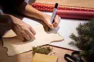 Free photo high angle woman writing letter for santa claus