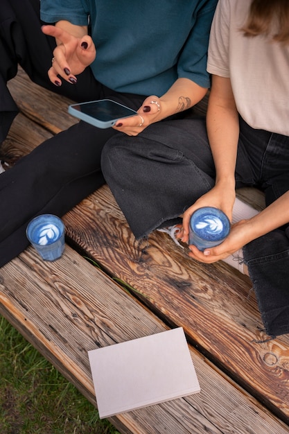 Free photo high angle women enjoying a blue matcha