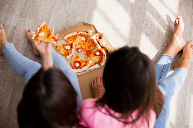 High angle women having pizza at home