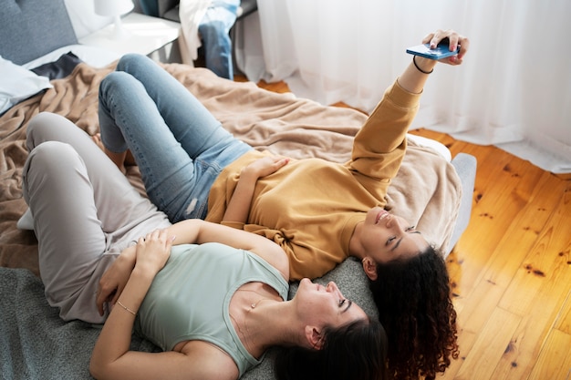 High angle women taking selfie at home
